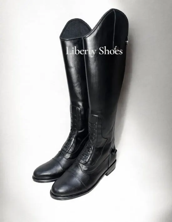 Sepasang sepatu boots kulit hitam setinggi lutut berdiri di depan latar putih bertulisan Liberty Shoes