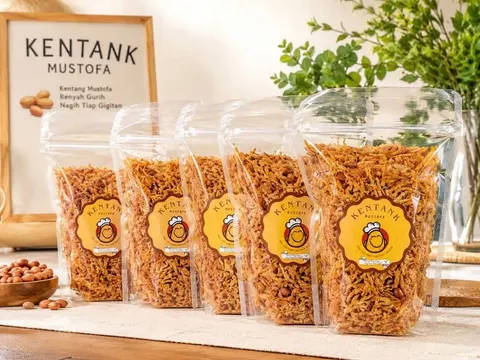 Lima pouch bening berisi kentang mustofa berlabel Kentank Mustofa di samping mangkuk kacang tanah