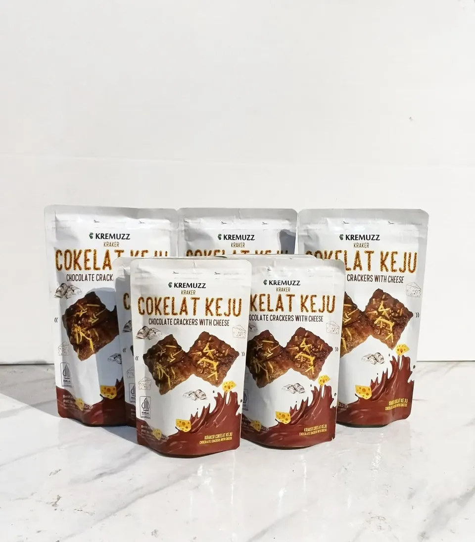 Lima kemasan pouch Kremuzz Cokelat Keju putih cokelat berdiri di atas meja marmer putih
