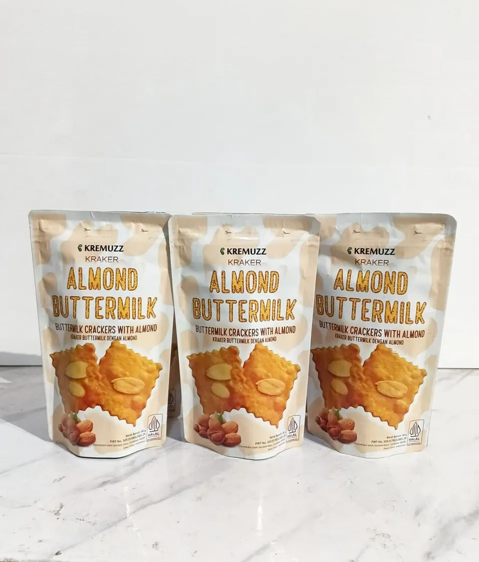 Tiga kemasan pouch Kremuzz Almond Buttermilk krem berjajar di atas meja marmer